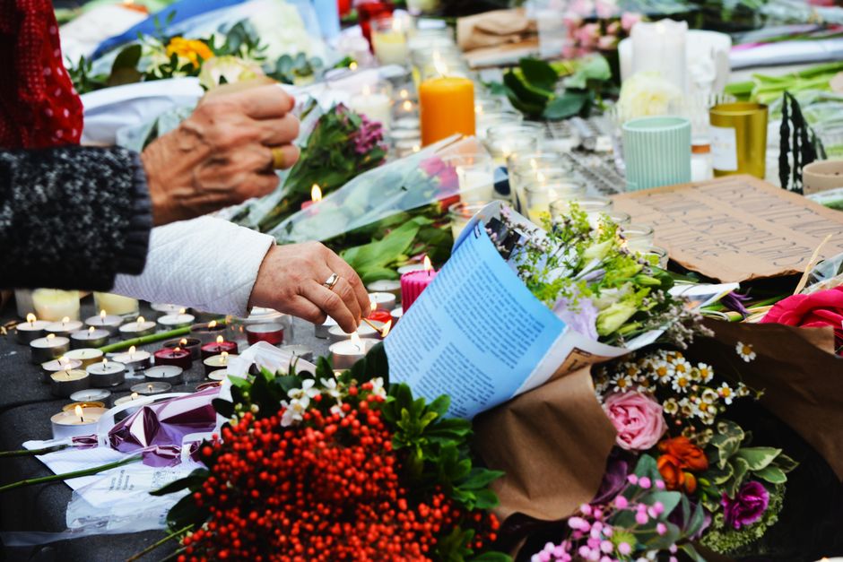 A touching scene of a memorial with flowers and candles.