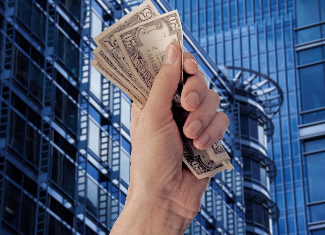 한-남자가-20달러와-5달러-짜리를-손에-한움큼-쥐고-있다.
