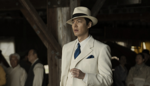 파친코 시즌1 백색 수트와 페도라를 입고 권력의 정점에서 부산 영도 시장의 조선인들을 내려다보는 고한수(이민호)의 압도적 존재감