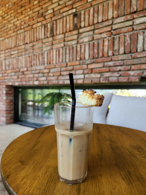 a cup of ice cafe latte is on the table 
