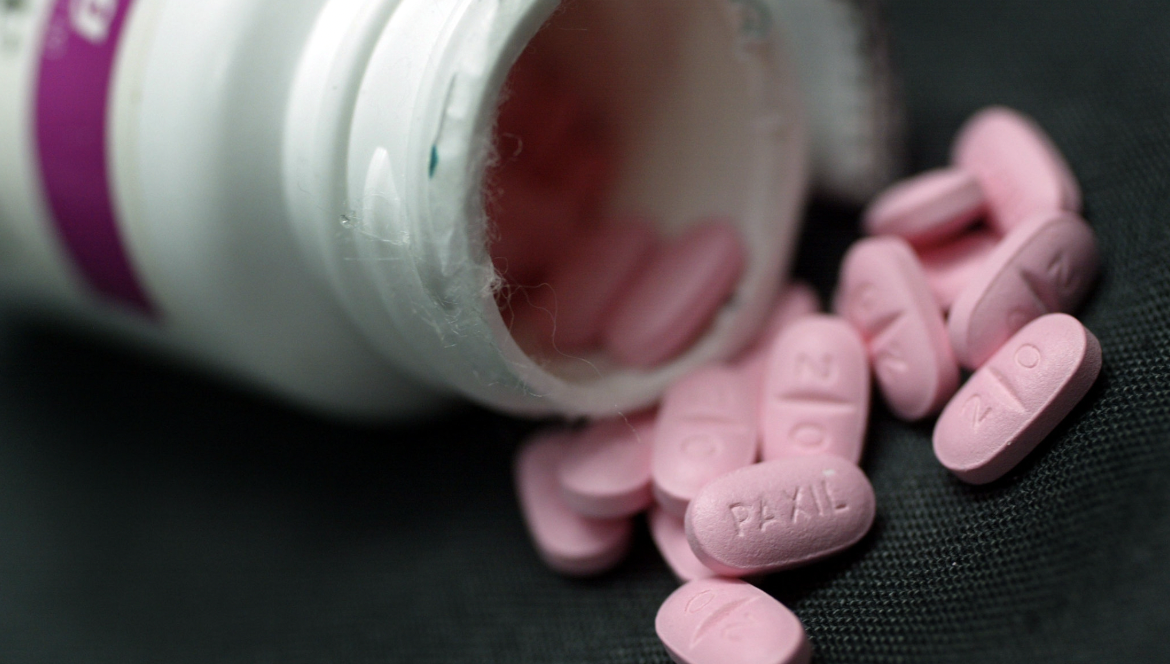 약통에서 분홍색 알약이 쏟아지고 있다