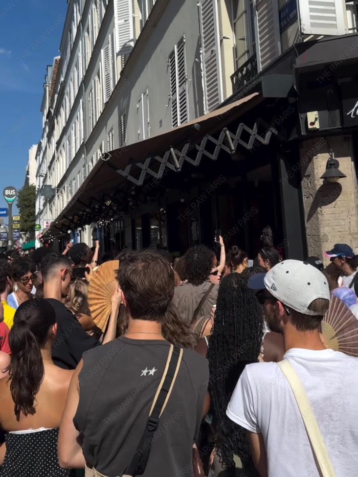People holding traditional fans to beat the intense summer heat at Fete de la Musique in Paris⁠