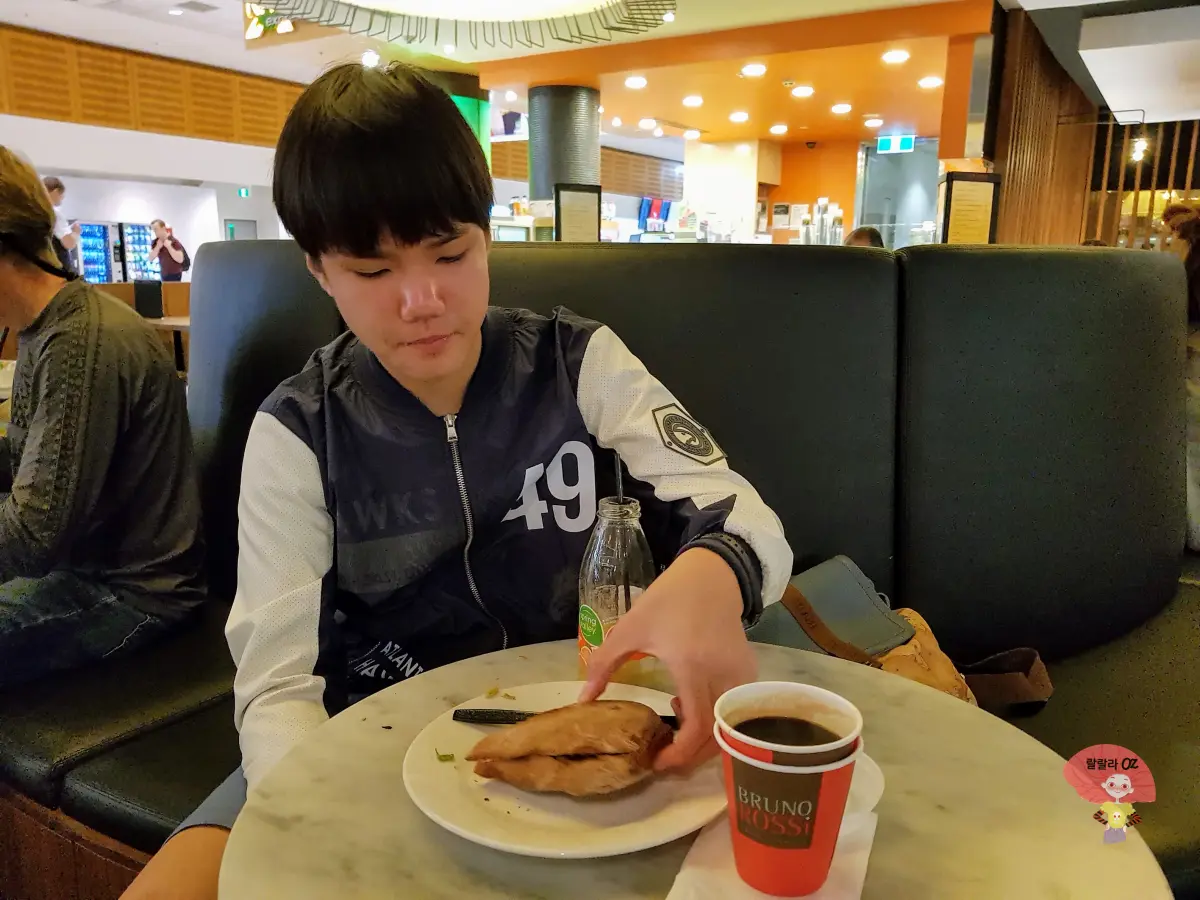 호주-시드니-공항-대기-중-멜버른행-비행기를-기다리며-빵-커피-주스를-먹는-아침식사-장면