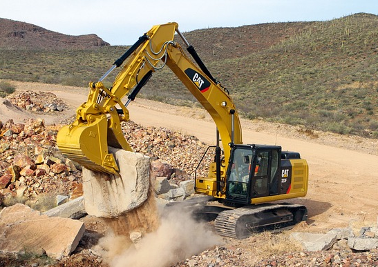Caterpillar's excavators are digging and moving the ground.