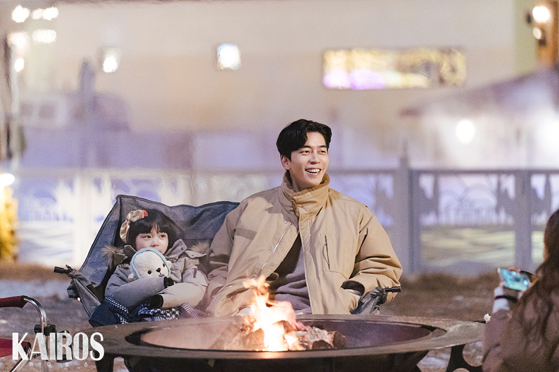 모닥불 앞 의자에서 아역 배우와 함께 웃는 안보현