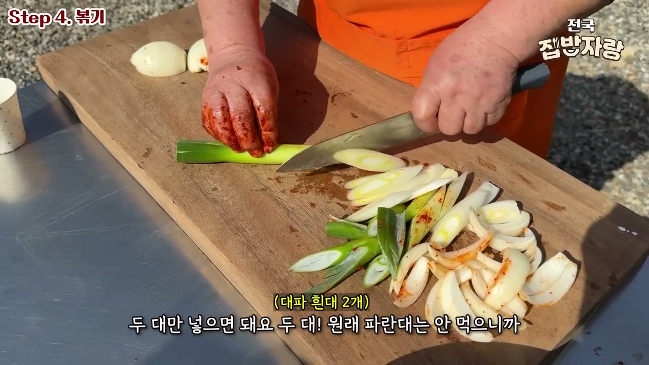 도마에서 대파와 양파를 써는 장면