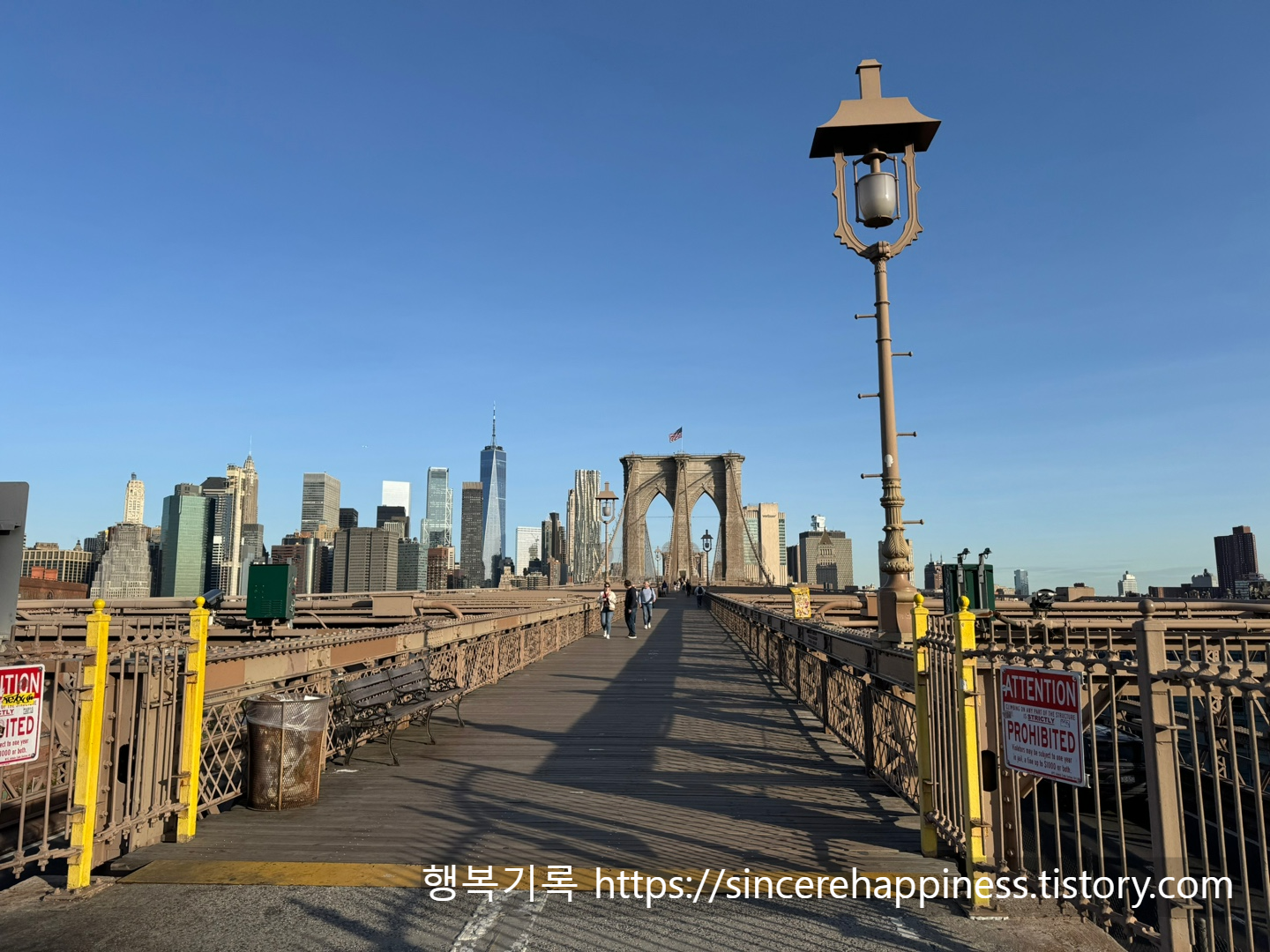 브루클린 브릿지의 상징적인 고딕 양식 아치를 배경으로 찍은 뉴욕 스냅 인생샷 명당