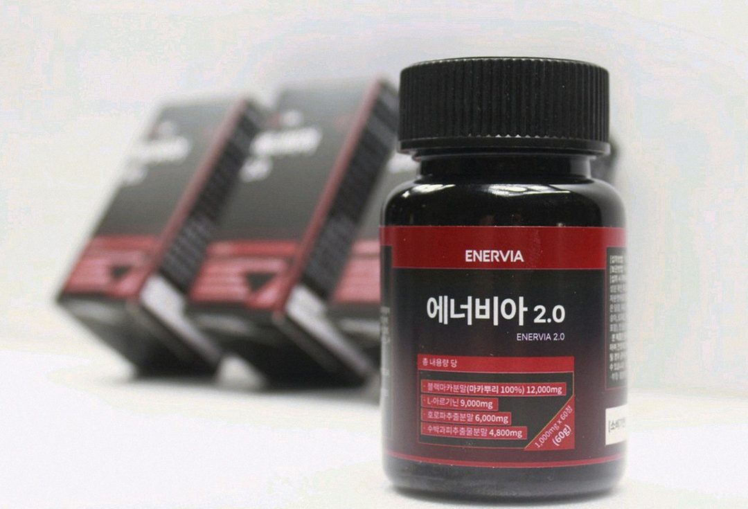 Korean Asian man in his 50s taking supplement before hiking