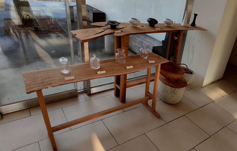 길다란 나무 벤치 위에 그릇들을 판매함