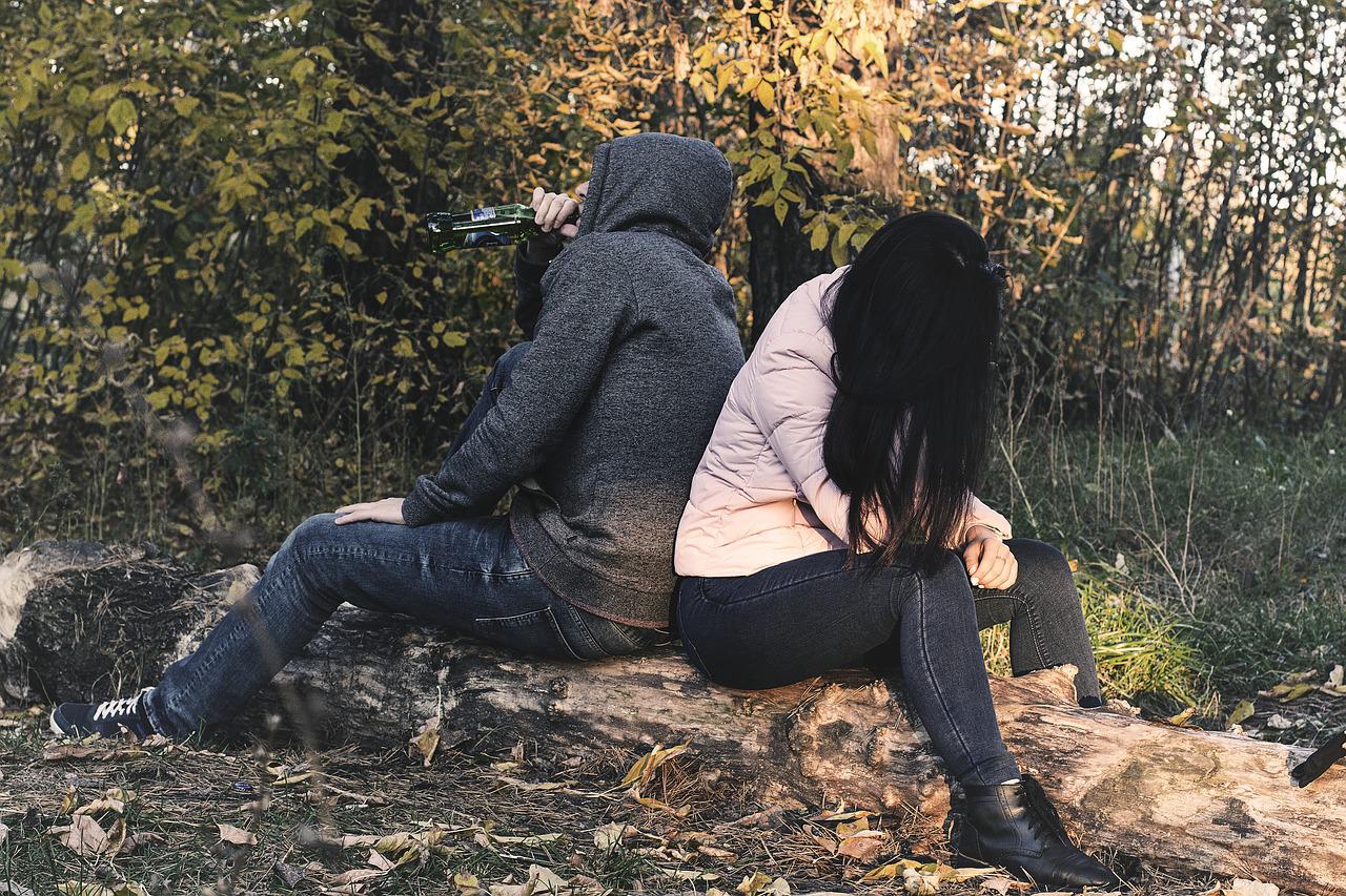 술마시며 등 맞대고 나무에 앉아있는 남녀