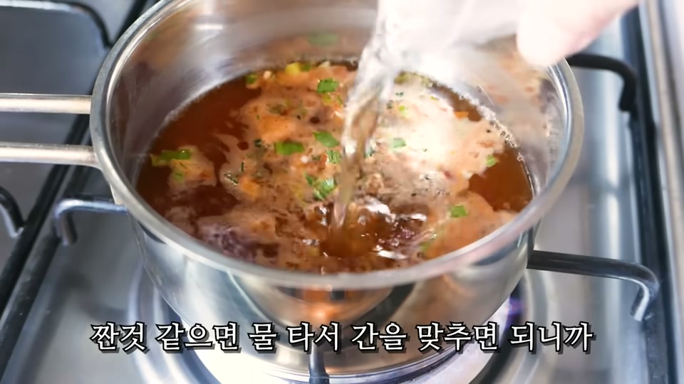 끓는 국물에 물을 더 넣어 간을 맞추는 장면
