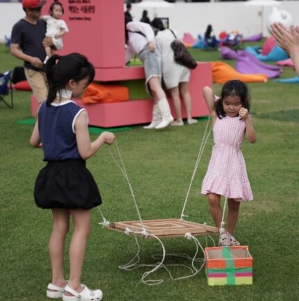 서울광장에서 놀이를 하고 있는 두 명의 여자아이