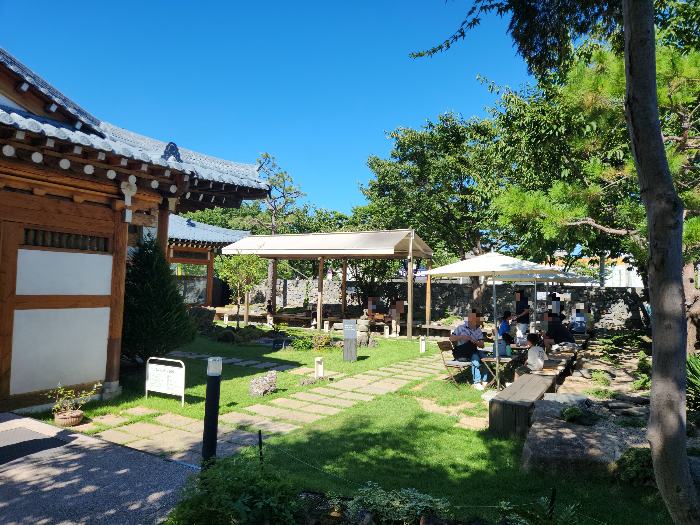 There is a tent next to the Hanok building.