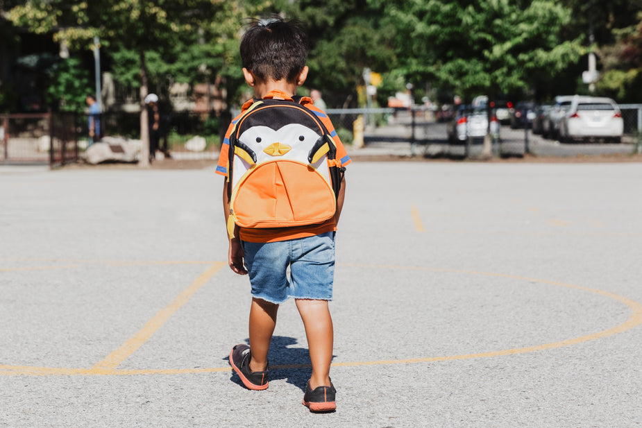 A boy strolling through the school playground