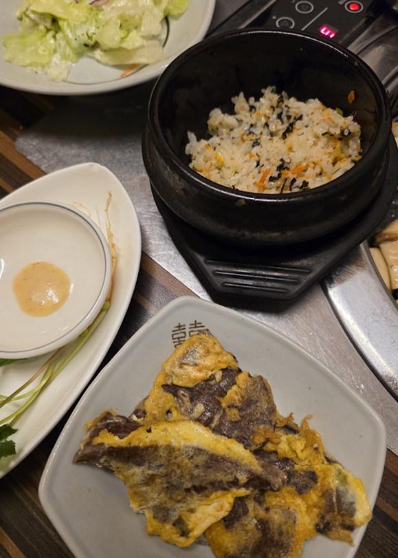 돌솥밥과 부침 요리가 함께 놓인 식사 구성 전경