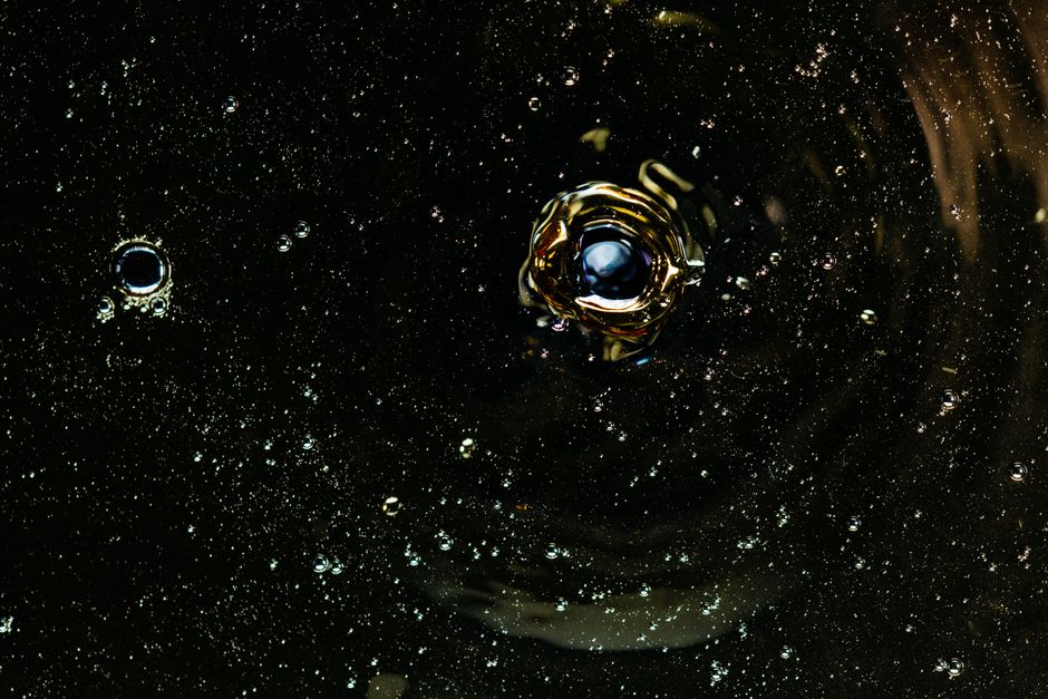 Top view of chaotic bubbles on rippling surface of dark water as abstract background