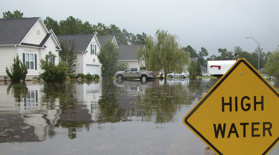 flooded houses with High Water sign