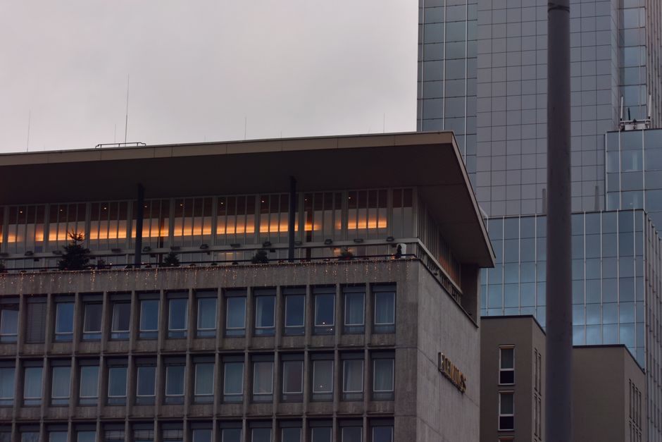 A contemporary skyscraper facade with warm lights at dusk, reflecting urban elegance.