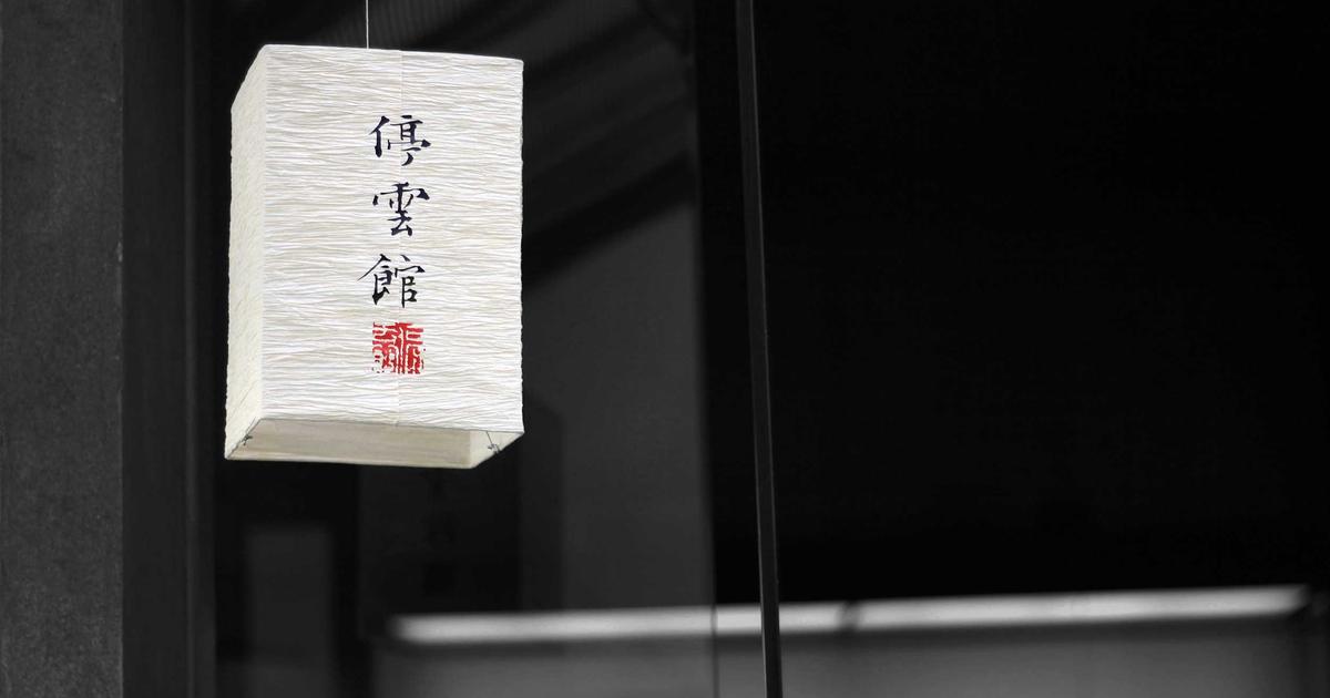 Young adult happily checking government benefits on a laptop with a cup of coffee, bright and hopeful atmosphere