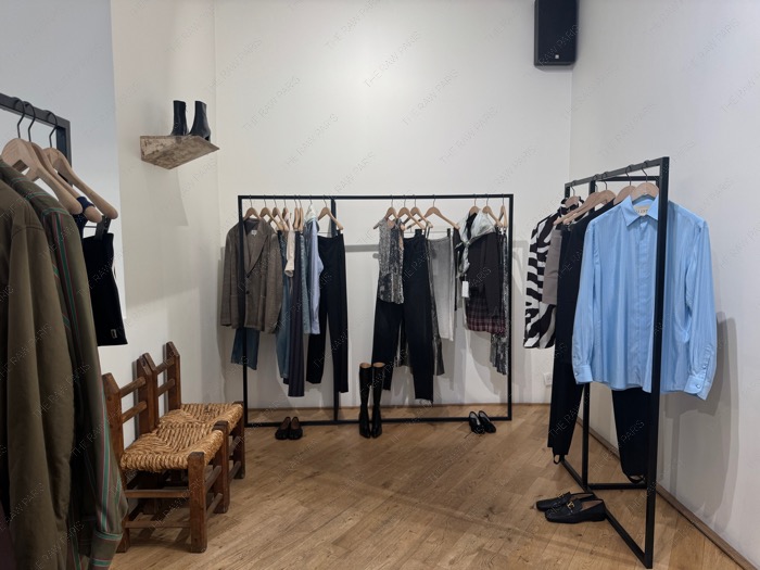 A minimalist clothing rack with designer shirts and trousers inside the styling room at The Broken Arm Paris ❘ Boutique The Broken Arm⁠
