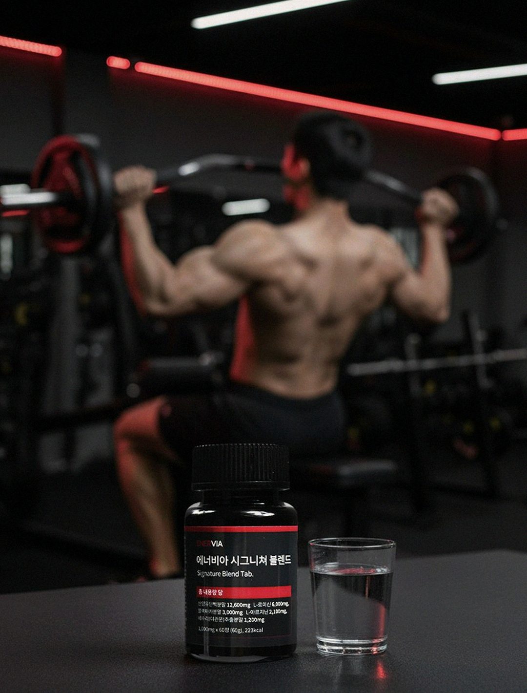 Korean Asian man taking supplements in gym locker room after exercise