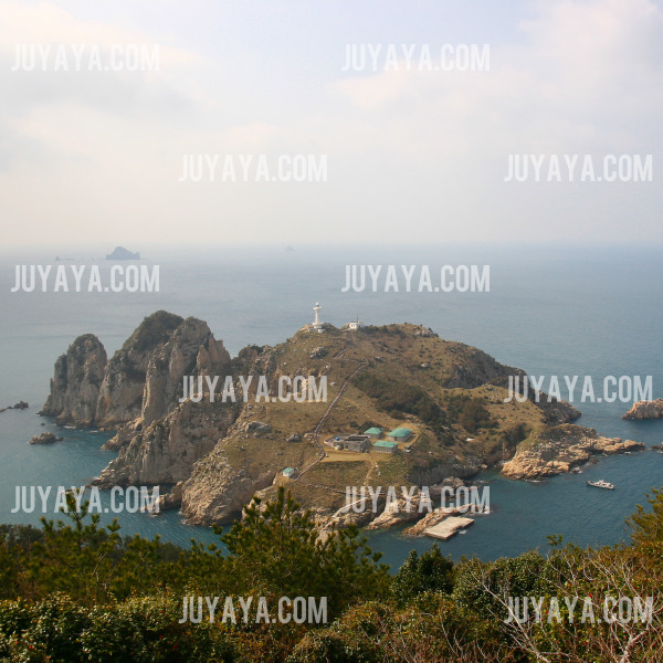 A beautiful aerial view of Somaemuldo Island, featuring the lighthouse and peaceful surroundings, with the ocean in the background.