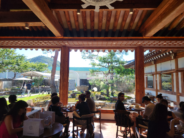 Inside the cafe, you can see the garden outside through the large glass windows.