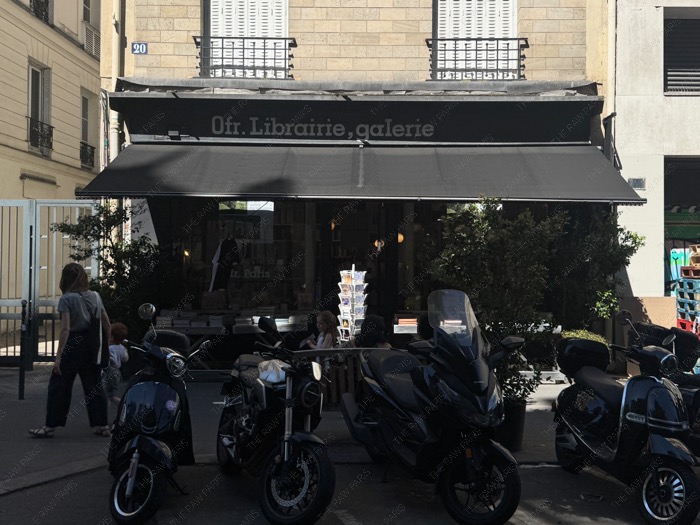 The black awning storefront of Ofr Librairie galerie bookshop in Le Marais Paris ❘ Ofr Paris⁠