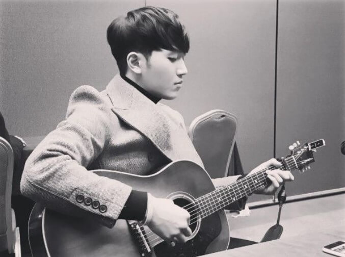 김필-stay-with-me-김필이-코트를-입고-앉아-기타를-연주하는-브라운-톤의-사진