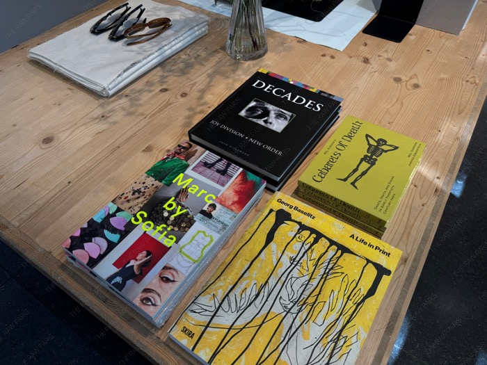 High end fashion art books like Marc by Sofia and Decades on a wooden display table inside The Broken Arm Paris ❘ The Broken Arm⁠