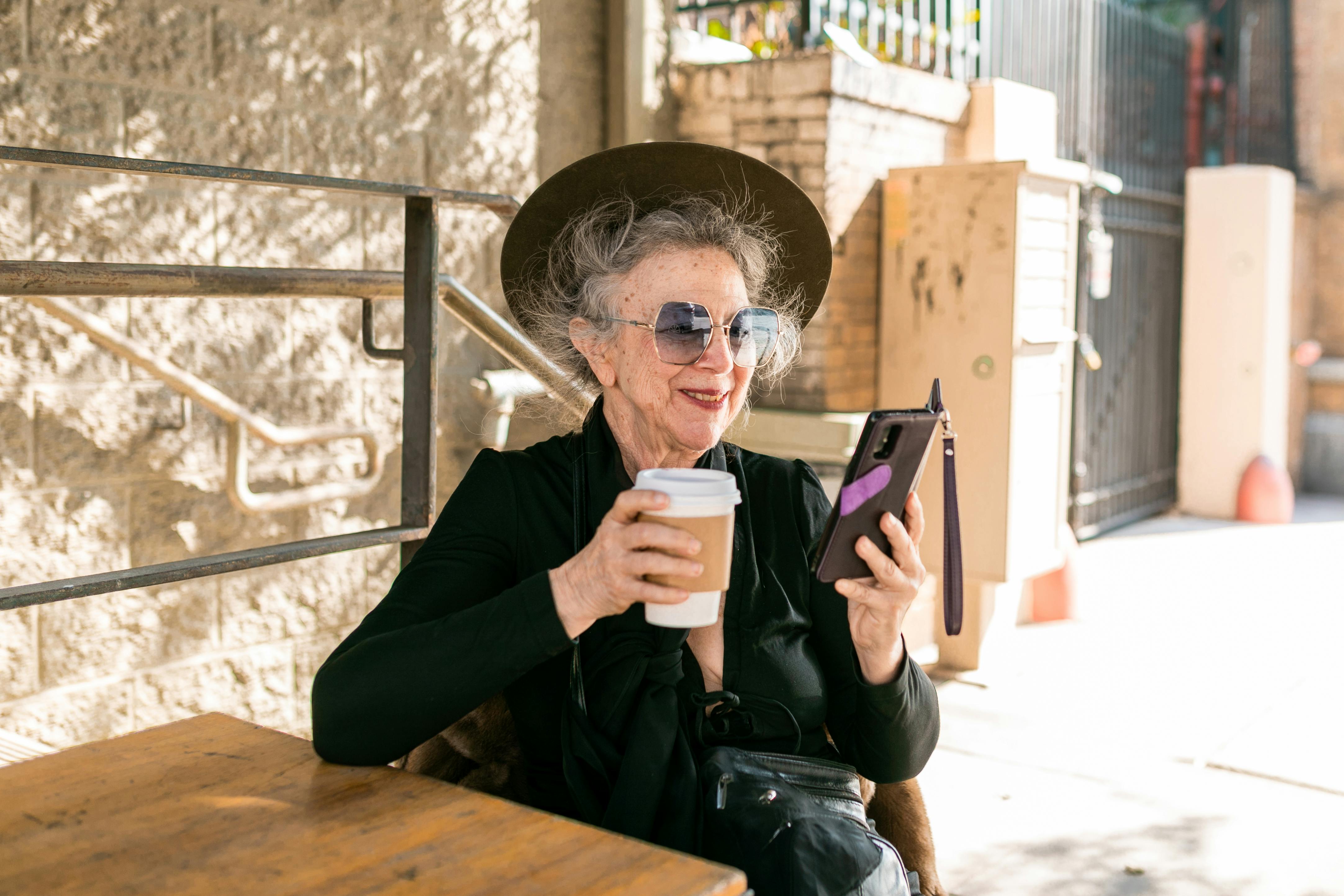 An elderly person enjoying a cup of coffee in a bright and peaceful morning setting