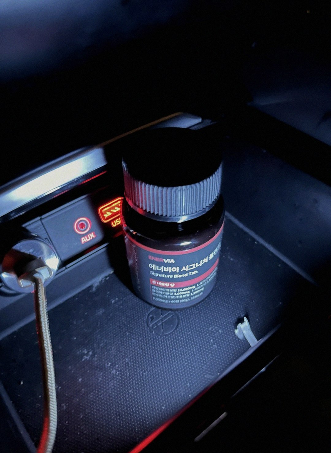enervia 2.0 bottle on desk with water