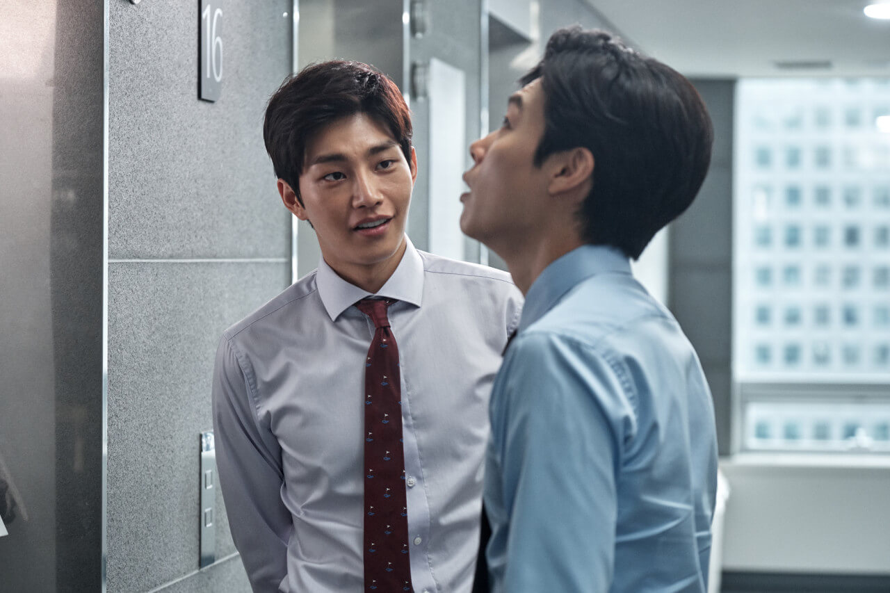 엘리베이터 앞에 서있는 회사원 두명