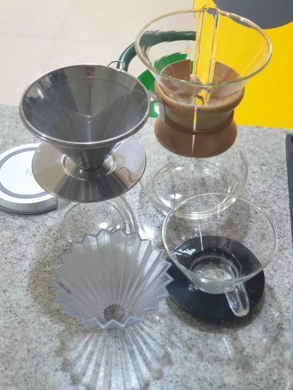 테이블 위에 메탈(이케아), 유리(케멕스, 칼리타 웨이브), 플라스틱(오리가미) 가 올려져 있다.