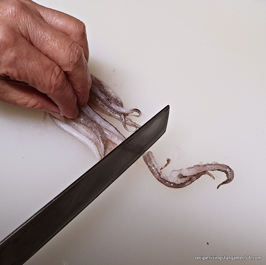 맛있는 오징어볶음에 들어갈 오징어의 긴다리를 잘라주는 사진