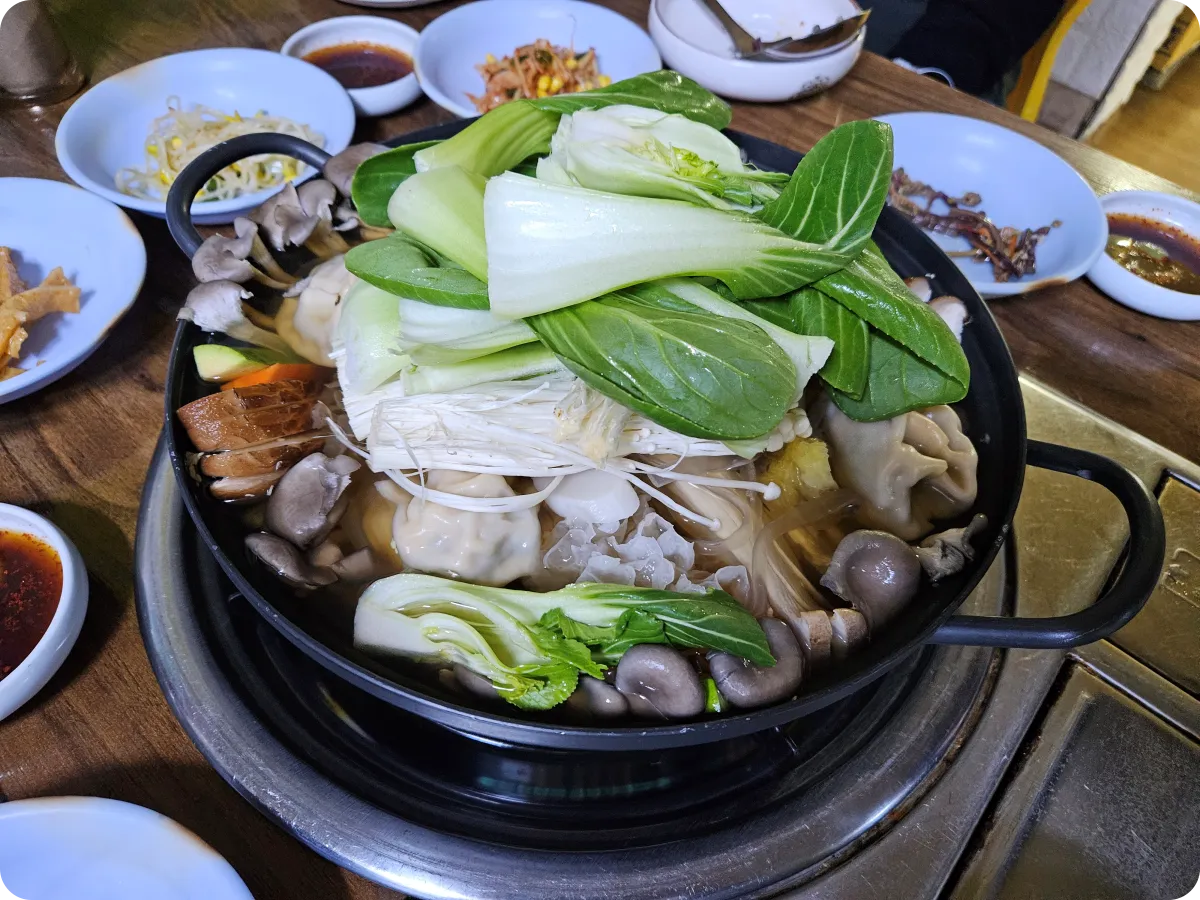 보배네-식당-만두전골-미듐사이즈-청경채-김치만두-당면-7가지반찬들