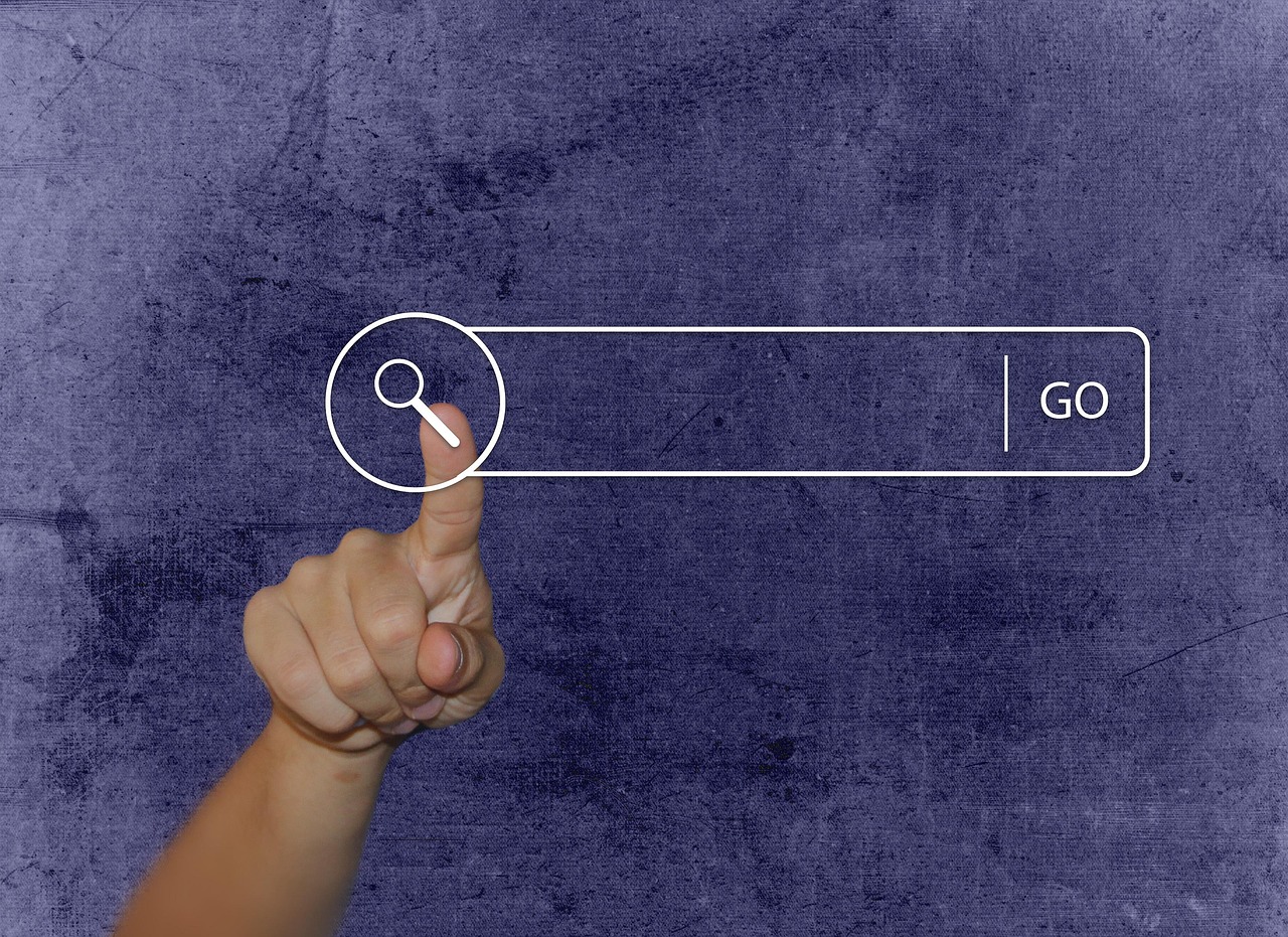 The finger pushing on the search button