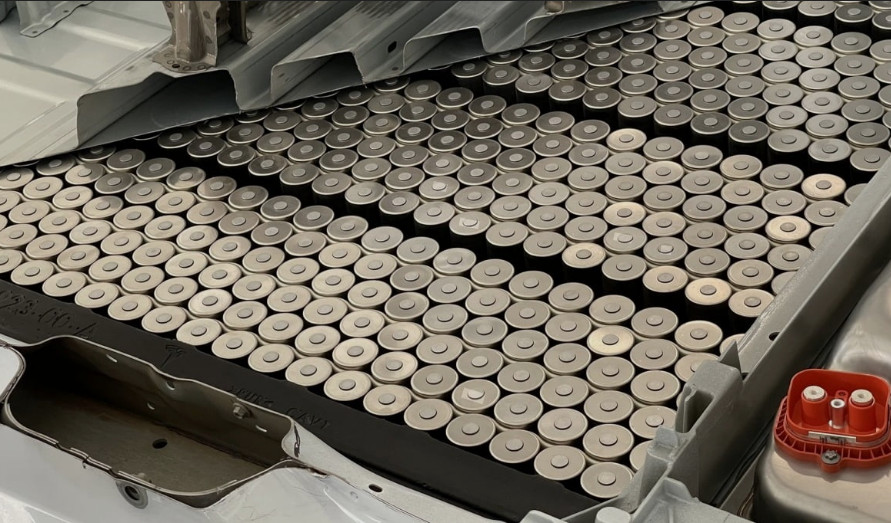 Close-up of Tesla's 4680 cylindrical battery cells on a Giga Factory production line.
