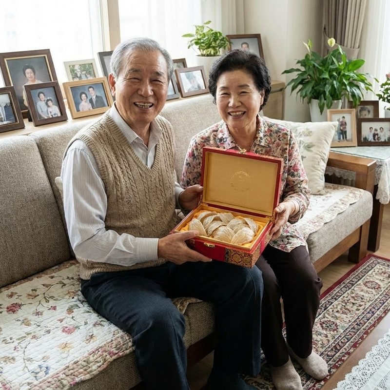 제비집 선물 상자를 받고 행복하게 웃고 있는 한국인 노부부의 모습