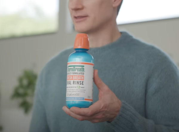 브라이언 존슨이 자신이 애용하는 구강청정제를 들고 있는 모습