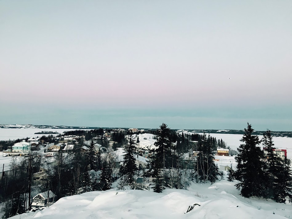 옐로나이프의 분홍빛 석양이 내려앉은 마을 풍경