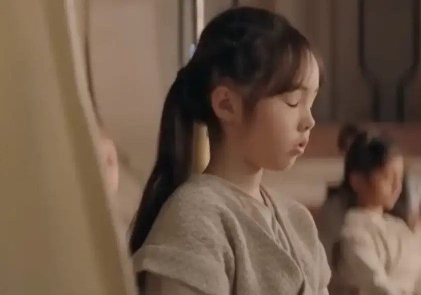 눈을 감고 명상하고 있는 흰옷입은 긴머리 소녀