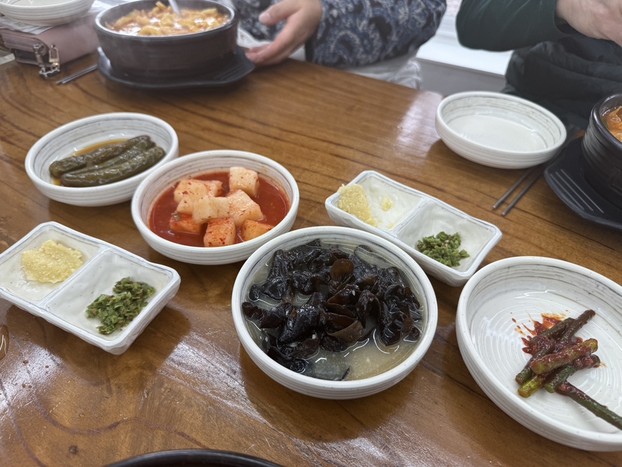 고추절임, 깍두기, 목이버섯 초무침, 마늘쫑과 땡초·다진 마늘이 담긴 기본 반찬