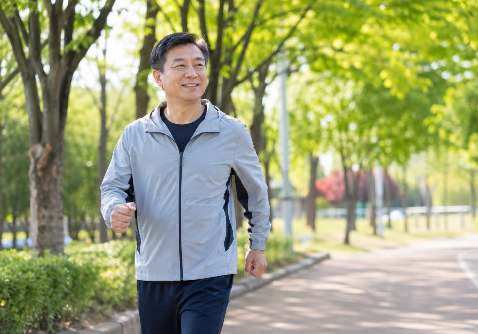50대 남성이 맑은 날 공원에서 걷기 운동하는 모습