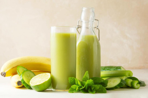Fresh green detox juice with cucumber, spinach, apple, and lemon