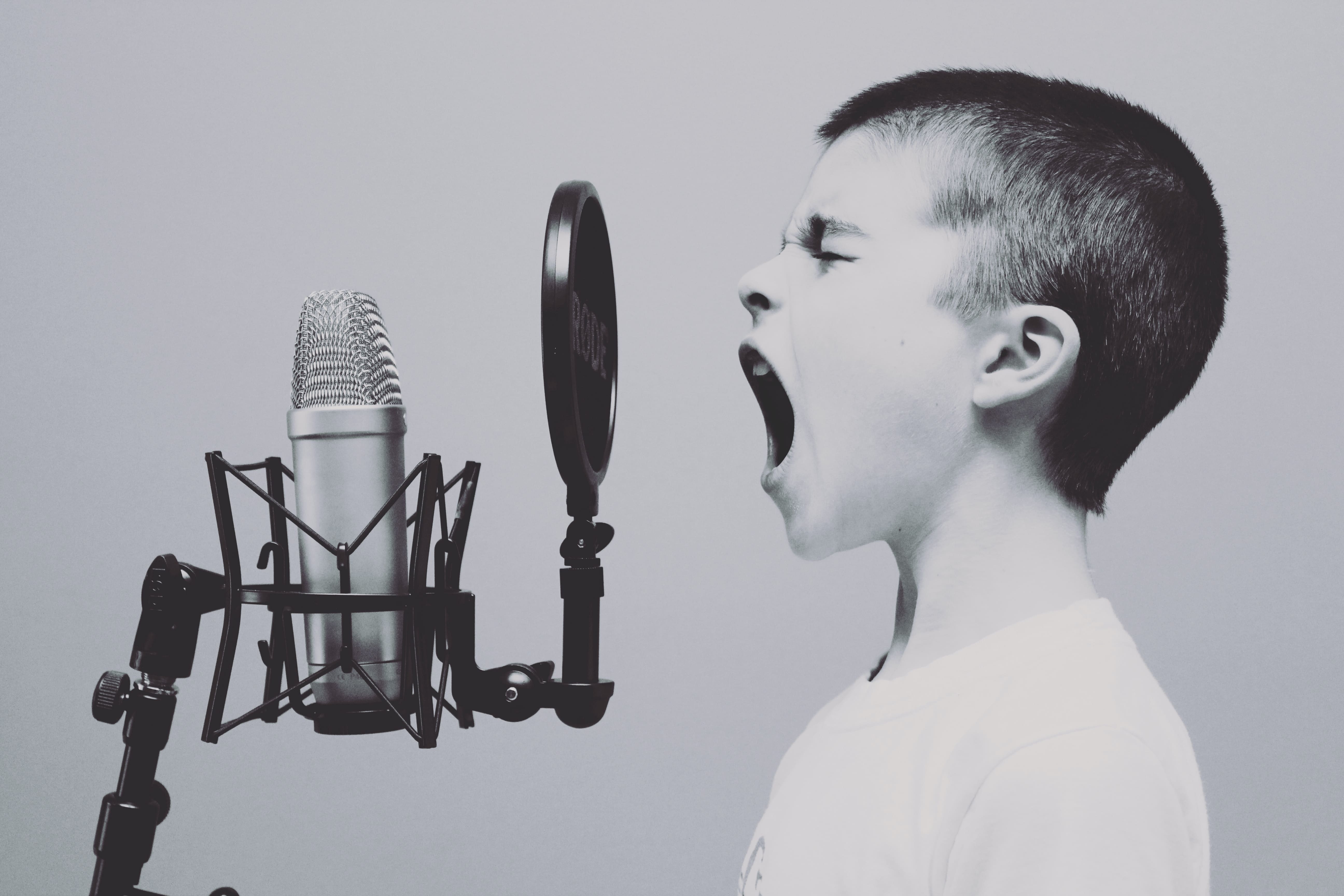 child screaming into microphone