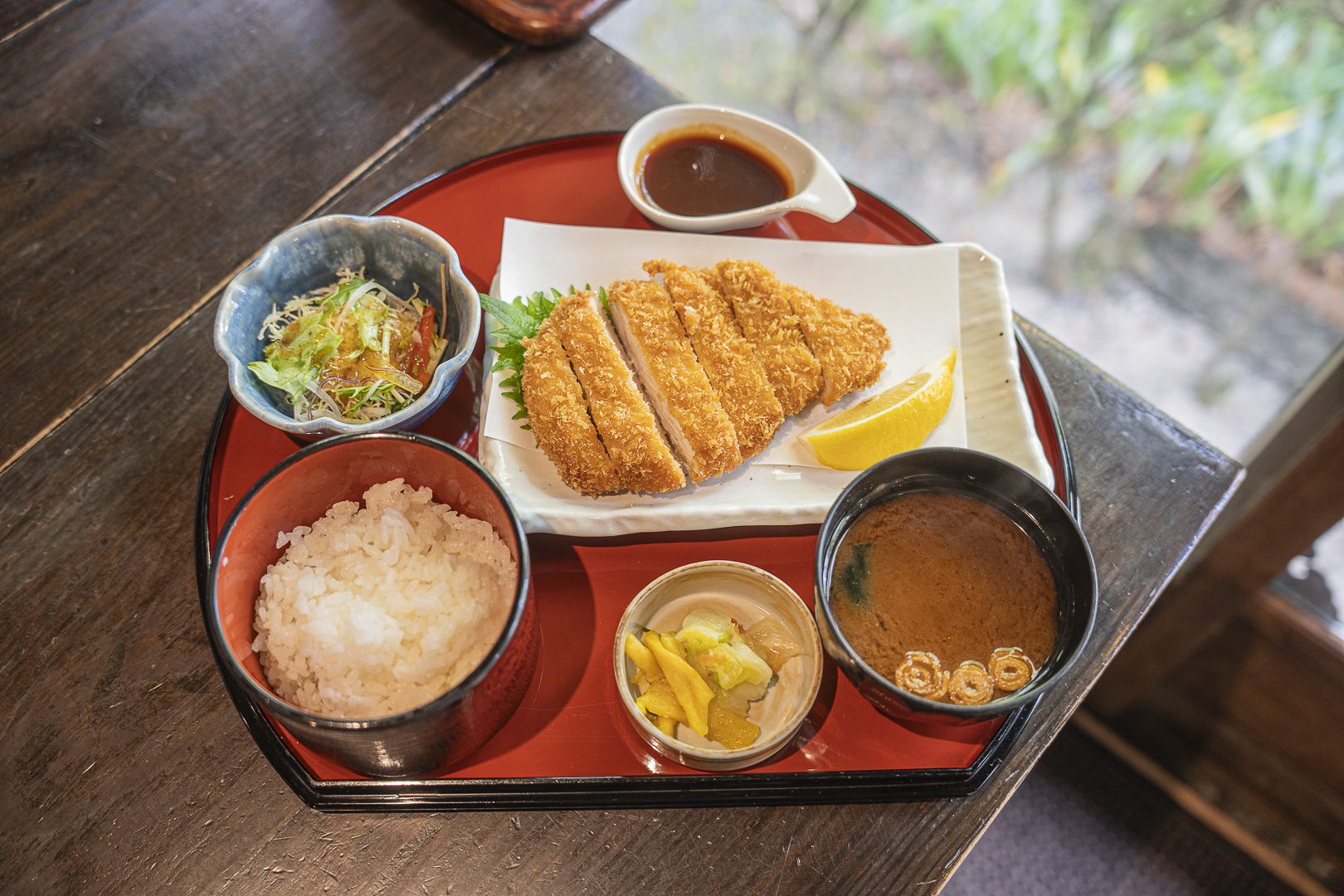 Wakadori: chicken katsu, rice, soup, salad and pickles arranged on a tray.