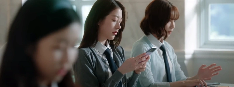 피라미드 게임에서 여고 학생들이 핸드폰으로 비밀 투표하는 장면