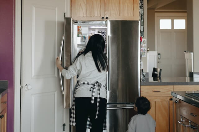 엄마와 아이가 냉장고에서 무언가 찾는 모습