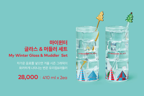 투명 컵에 트리장식과 금색, 초록색 트리 스트로우가 꽂힌 유리컵